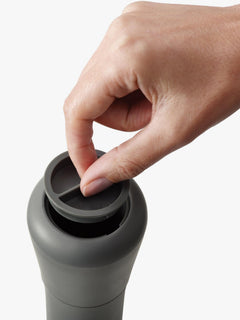 Close-up of the charcoal Milltop pepper mill with its lift-off seal opened