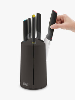 Hand lifting a knife from the rotating Elevate carousel block