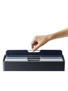 Hand lifting a Folio board out of the tiered case by its steel bar