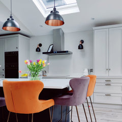 Pewter and copper dome pendant above a kitchen island
