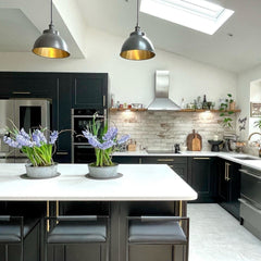 Pewter dome pendant with copper interior in a monochrome kitchen