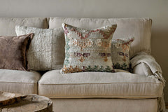 Dantri soft grey cushion cover on a linen sofa with plain cushions