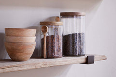 Ibo shelf holding stacked bowls and glass storage jars