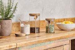 Kossi storage jars holding dry goods on a reclaimed wood kitchen shelf