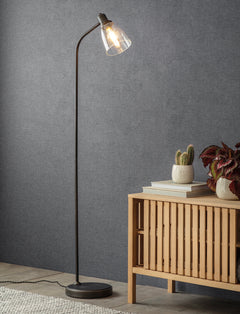 Lit Hoxton Dome floor lamp standing beside a slatted wooden sideboard against a grey wall