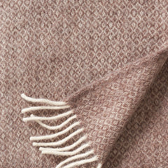 Close-up of the small-diamond weave and cream fringe on the Sand Lima throw