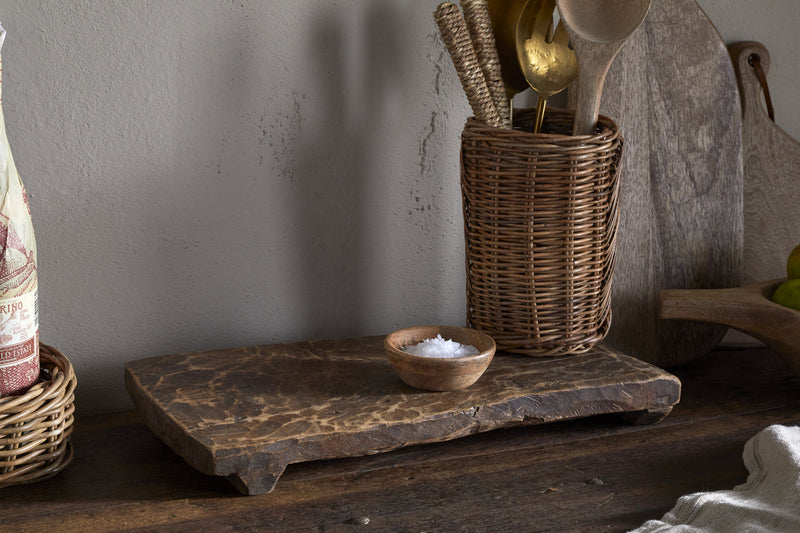 Kaveeta reclaimed wood serving board at an angle on a white background, showing the carved feet