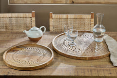Namuna trays on a dining table set with glassware and a carafe