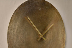 Close view of the Okota clock face showing the slim brass hands