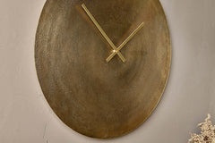 Angled view of the hand-finished antique brass clock face