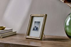 Pambani frame holding a black and white photograph on a wooden sideboard
