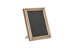 Angled view of the Pambani antique brass frame standing on its easel