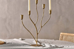 Detail of the branching antique brass arms and cupped candle holders
