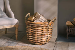 Rattan Chunky Basket filled with logs beside a fireside armchair