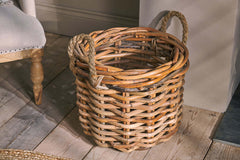 Close view of the Rattan Chunky Basket on a painted wooden floor, showing the chunky weave and rope handles