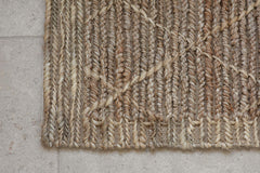 Close-up of the braided jute weave and diamond motif on the Vandi doormat