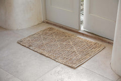 Vandi natural jute doormat laid on a tiled floor inside a front door