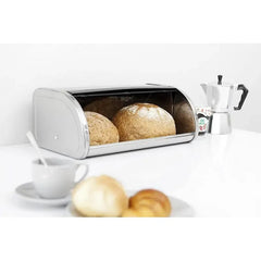 Roll Top bread bin open on a white worktop with two loaves inside