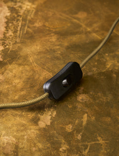 Detail of the in-line on/off switch on the olive green braided flex of the Kelmscot table lamp