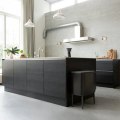 Matt black Bo Touch Bin standing beside a dark kitchen island
