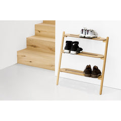 Heel Bar oak shoe rack in a hallway beside a light timber staircase