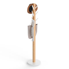 Umbra Flapper freestanding coat rack with natural rubberwood pole and white base on a plain background