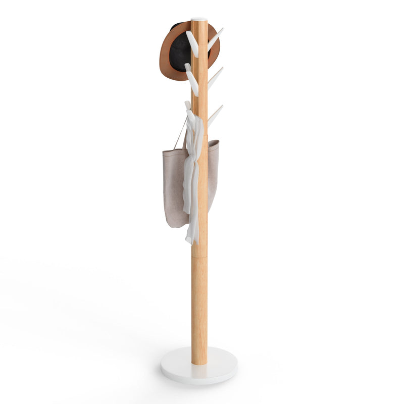 Umbra Flapper freestanding coat rack with natural rubberwood pole and white base on a plain background