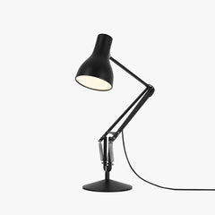 Anglepoise Type 75 desk lamp in jet black shown from the side with the arm raised