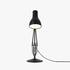 Anglepoise Type 75 desk lamp in jet black viewed front on, showing the springs and disc base
